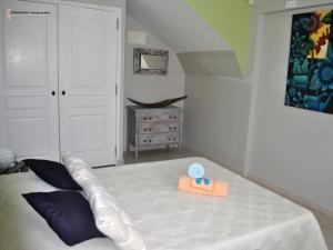 a bedroom with a bed with an infront of it with avisor at CoCoKreyol - " GRENADINE " in Les Trois-Îlets