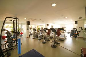 a gym with a bunch of treadmills and machines at Estrela Apartment by Moje Holiday in Luz +12 photos