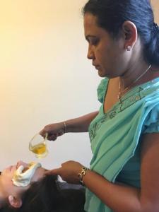 a woman is holding a glass of wine at Ayurishi Villa in Hikkaduwa