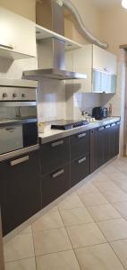 a kitchen with stainless steel appliances in a kitchen at Elegantia Domina apartment in the center in Fiumicino +6 photos