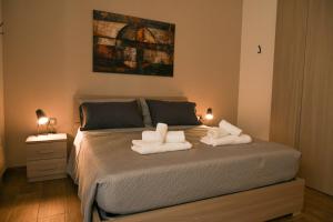 a bedroom with a bed with towels on it at Casa MoniK in Brindisi +53 photos