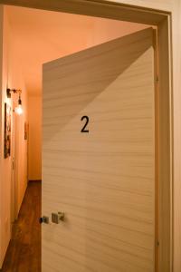 a white garage door with the number on it at Casa MoniK in Brindisi