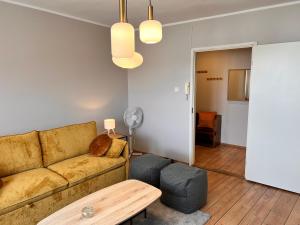a living room with a couch and a table at Reval Residences City Center in Tallinn