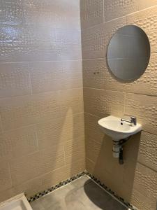 a bathroom with a sink and a mirror at Hôtel Le Capitol in Marseille