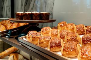 a bunch of pastries on display in a bakery at Hilton Kyoto in Kyoto