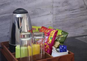 a wooden tray with a coffee maker and snacks at Royalpark resort in Jāmb