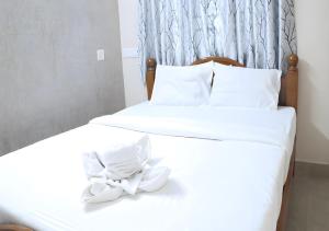 two beds with white sheets and a bow on them at Royalpark resort in Jāmb