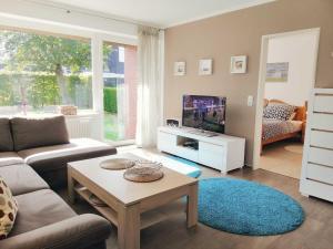 a living room with a couch and a table at Ferienhaus Hanni in Schillig +7 photos