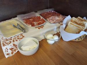 a table topped with different types of bread and other foods at Casa Vintago b&b in Savio di Ravenna