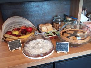 a counter with different types of bread and fruit on it at Casa Vintago b&b in Savio di Ravenna