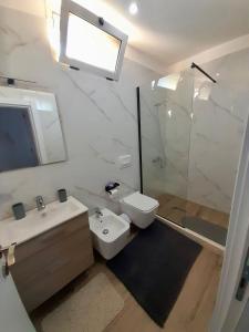 a bathroom with a sink and a toilet and a shower at Natan Home in Shkodër