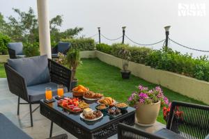 a tray of food on a table on a patio at StayVista at Villa Mirador with BBQ, Bonfire, WiFi in Rishīkesh +24 photos