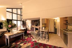 a kitchen and living room with a table and chairs at Bernti's Mountain Inn in Thredbo