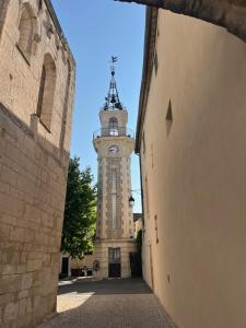 a building with a clock tower in the distance at Heaven Chambres chez l'habitant in Valergues