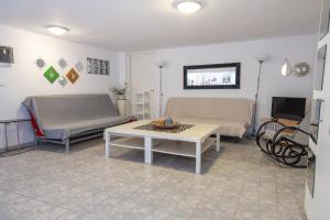 a living room with two beds and a table at Mitro Seaview Apartments in Nea Vrasna