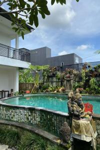 a swimming pool in the middle of a house at Budha House Ubud in Ubud