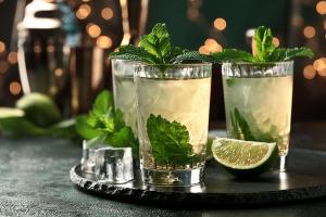 two glasses with mint and a lime on a table at Casa Greina B&B in Surrein