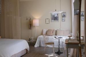 a bedroom with a bed and a table and a lamp at Casa Fellin 1891 B&B in Cles +35 photos