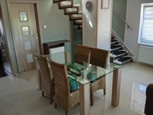 a dining room with a glass table and chairs at Apartmán Domažlice in Domažlice +1 photo
