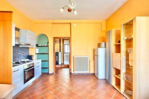 Il comprend une cuisine avec des murs jaunes et du carrelage. dans l'établissement La Dimora del Tasso - Garden, Terrace & Mountain View, à Carlazzo