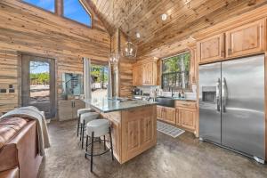 a kitchen with wooden cabinets and a stainless steel refrigerator at NEW Woodland Escape with Spa & Fire pit - Sleeps 4 in Mount Herman +56 photos