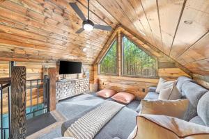 a living room with a couch and a tv in a cabin at NEW Woodland Escape with Spa & Fire pit - Sleeps 4 in Mount Herman