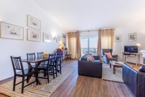 un salon avec une table et des chaises dans l'établissement CoolHouses Algarve Luz, 3 Bed Townhouse w/ beautiful sea view, Luz Bay 76, à Luz