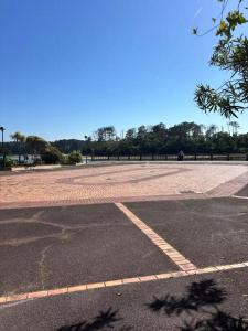 an empty parking lot with a park in the background at Appart proche du lac et plages in Soustons +2 photos