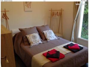 a bedroom with a bed with two towels on it at villa Paty in Bonifacio