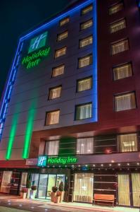 a hotel building with a happy hour sign on it at Holiday Inn Plovdiv by IHG in Plovdiv