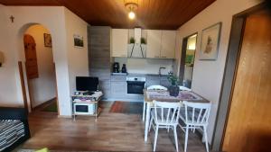 a kitchen with a table and chairs in a room at Appartement Philips in Flachau