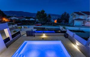 a swimming pool in the backyard of a house at night at Lovely Home In Pridraga in Pridraga +37 photos