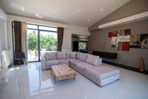 a living room with a couch and a coffee table at Villa Luce in Kos