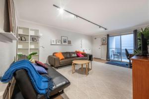 a living room with a couch and a table at Stylish 2BR Apartment in Kingston Close to Lake in Kingston 