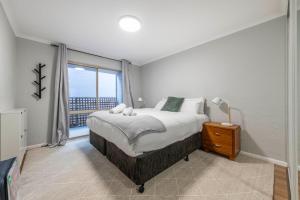 a bedroom with a large bed and a window at Stylish 2BR Apartment in Kingston Close to Lake in Kingston 