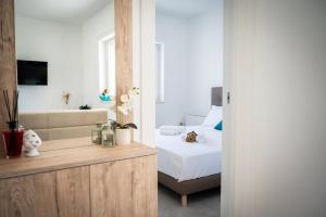 a bedroom with a bed and a couch in a room at Likehome Ponente Levante 2 Ville luxury Pool 12pxs in Taranto +52 photos
