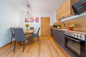 a kitchen with a table and chairs and a dining room at Oetztaler Lausbubenhaus Max & Moritz in Ötztal-Bahnhof