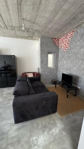 a living room with a couch and a table at Cozy loft-duplex penthouse in Il-Gżira