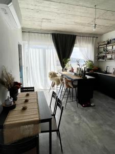a living room with a table and chairs and a kitchen at Cozy loft-duplex penthouse in Il-Gżira