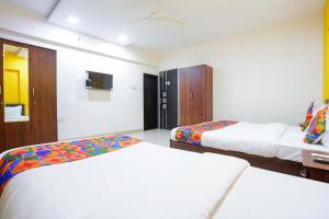 Postel nebo postele na pokoji v ubytování FabHotel Rio House Apartment
