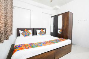 Postel nebo postele na pokoji v ubytování FabHotel Rio House Apartment