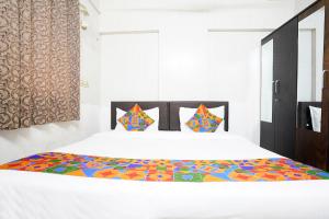 Postel nebo postele na pokoji v ubytování FabHotel Rio House Apartment