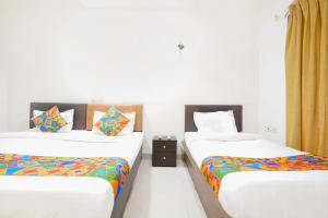 Postel nebo postele na pokoji v ubytování FabHotel Rio House Apartment