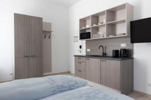 a small kitchen with a bed and a sink at Haus Viasana in Bad Ischl