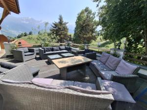 a patio with couches and a table and chairs at Pension Razil XO in Ladis