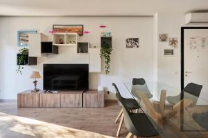 a living room with a glass table and chairs at Villa Gelsomino in Lido di Jesolo