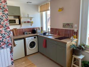 a kitchen with a sink and a washing machine at Inspired space in Le Mans