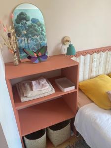 a dressing table with a mirror and a bed at Inspired space in Le Mans +3 photos