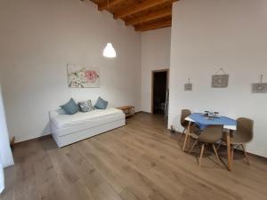 a living room with a white couch and a table at Mamanis Studios in Loutra Edipsou