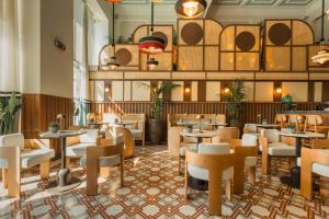 a restaurant with tables and chairs in a room at ON Residence - Small Luxury Hotels of the World in Thessaloniki